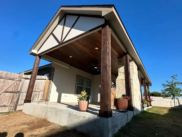 Gable patio cover with cedar beams and stone columns
