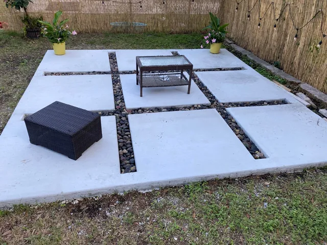 Concrete slab patio with river rock joints